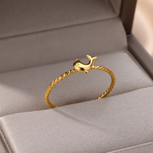 Detail of 18k gold plated stainless steel twisted rope ring with dolphin charm