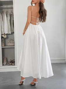 Detailed back view of a white sundress showing lace-up ties and button accents