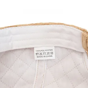 Detailed macro view of corduroy baseball cap interior featuring quilted lining and care label