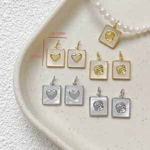 Detail of 10.5x16mm heart and rose mother-of-pearl charms for DIY jewelry making