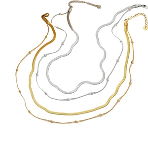 Minimalist stainless steel jewelry set featuring flat snake chain and beaded necklace in gold