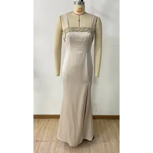 Detailed view of sequin bodice and high slit on champagne satin evening gown