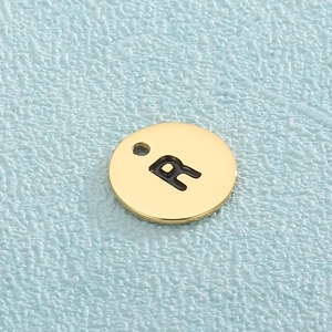 Minimalist gold stainless steel round charm with engraved letter R and hanging hole