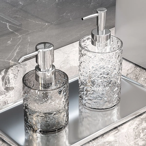 Elegant hammered glass soap dispenser set with chrome pump on luxury metal tray