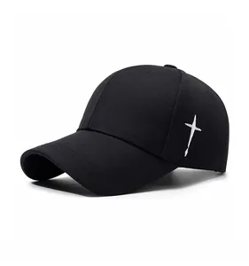 Detailed side view showing white cross embroidery on a black cotton twill baseball cap