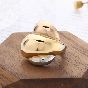 Macro shot of sculptural dual-tone 18k gold plated heart ring with mirror finish