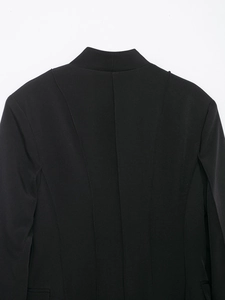 Macro shot of vertical slimming seams and stand-up collar on black blazer back