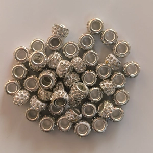 Close-up of silver-plated large hole spacer beads with crystal rhinestones for DIY crafts