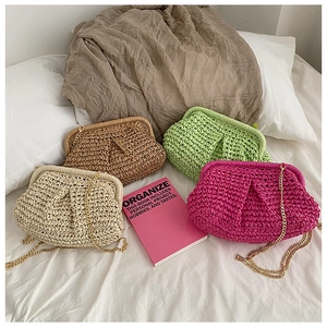 Flat lay of straw clutch bags in four colors with gold chain straps and metal frames