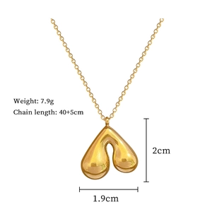 Detailed view of titanium gold heart pendant with dimensions 1.9cm x 2cm and 7.9g weight