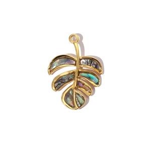 Detailed macro view of a leaf pendant featuring golden frame and iridescent abalone inlay