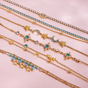 Chic gold-plated star and moon charm bracelet set with blue crystals and evil eye motif