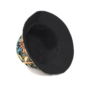 Detail of reversible bucket hat showing black interior and tropical leaf print pattern