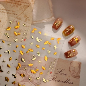 Golden ginkgo leaf nail art stickers with elegant autumn designs and calligraphy accents