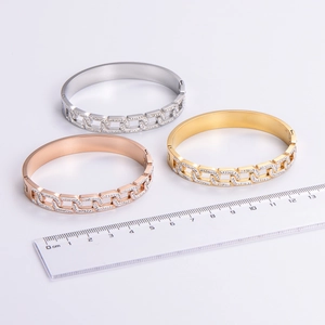 Three-piece set of crossed crystal bangles in gold, silver, and rose gold finishes
