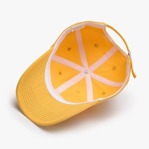 Inside view of yellow cotton baseball cap showing internal panels and sweatband