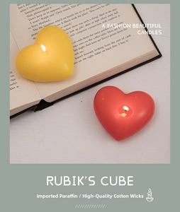 Detail of red and yellow heart candles with premium cotton wick and paraffin wax texture