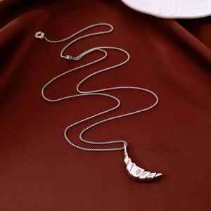 Detailed macro view of 18k gold plated moon pendant with textured surface and silver chain