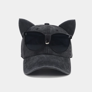 Detail of creative cat ear baseball cap with integrated sunglasses and washed denim fabric