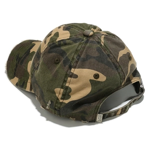 Close-up of distressed vintage camo baseball cap featuring worn edges and adjustable strap