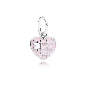 Silver puzzle heart charm with pink enamel inlay and metal loop for DIY jewelry making