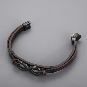 Close-up of brown braided leather strap with black stainless steel infinity clasp