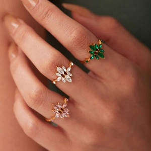 French style 18K gold plated stainless steel rings with zircon leaf designs on a hand