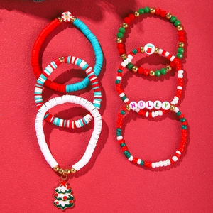 Detailed view of Christmas bead bracelet set with Holly charms and gingerbread man pendants
