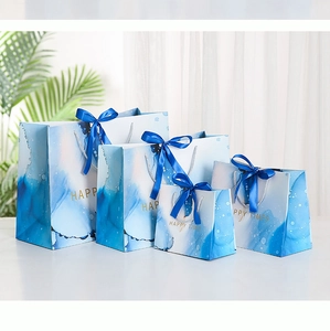 Blue marble gift bags with gold Happy Times text and satin handles in four sizes