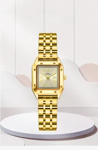 Close-up of gold vintage square watch with Roman numerals and metal chain bracelet