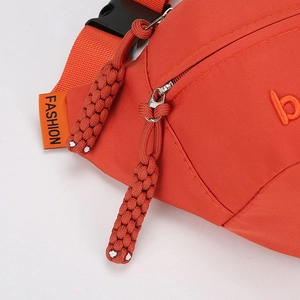 Orange canvas crossbody chest bag for women with woven knot zipper and fashion tag