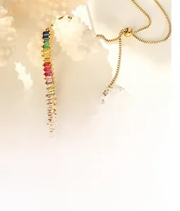 Detail of colorful baguette-cut gemstones on a sliding 18k gold-plated chain