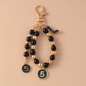 Personalized black and gold beaded keychain with rhinestone number 5 and high heel charms