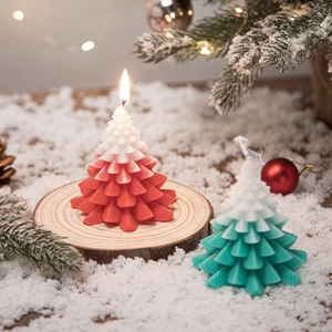 Christmas tree scented candles with red and green gradient finish on snow and wood base