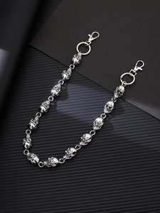 Detailed view of silver skull punk metal chain with lobster clasps on black background