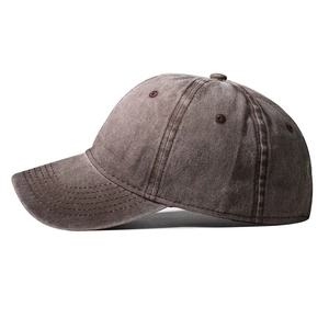 Detail of vintage washed dark brown cotton baseball cap showing texture and stitching