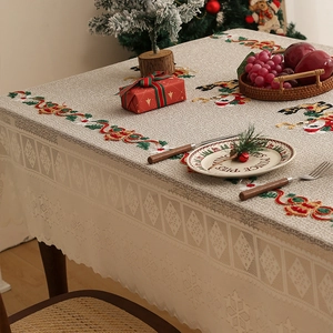 Detailed embroidery of Christmas bells and lace edge on high-quality festive tablecloth
