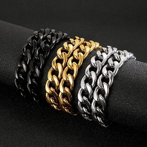 Detailed view of Cuban chain bracelets in black, gold, and silver finishes on a display