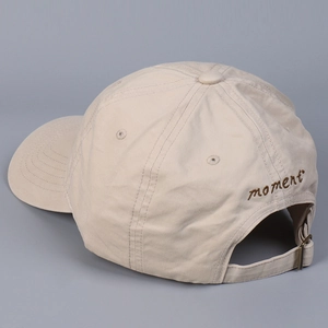Detail of adjustable metal buckle and moment embroidery on back of cotton baseball cap