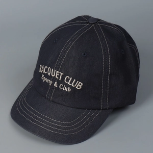 Close-up detail of the white letter embroidery on a navy vintage baseball cap