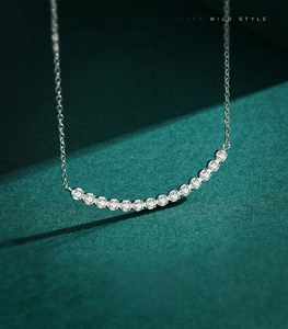 Close-up of 925 sterling silver necklace featuring curved rows of sparkling cubic zirconia