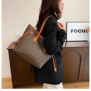 Macro detail of the geometric print tote bag featuring side drawstrings and leather handles