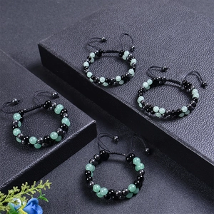 Detail of adjustable double-layer beaded bracelets with green aventurine and black magnetic stones
