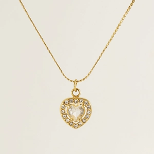 Macro shot of gold heart pendant necklace featuring central zircon and halo of small crystals
