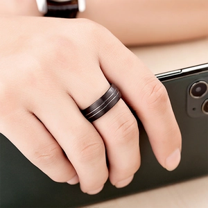 Brushed black tungsten ring for men featuring silver stripes on a finger