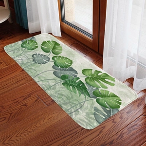 Tropical monstera leaf flannel mat displayed on dark wood flooring near window curtains