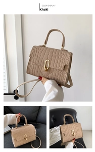 Detailed close-up of khaki faux crocodile texture leather bag with elegant golden clasp