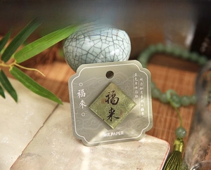 Close-up of acrylic fridge magnet with Chinese blessing characters in a traditional setting