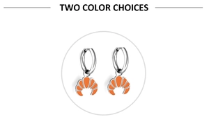 Detailed view of silver croissant fruit earrings with bright orange enamel finish