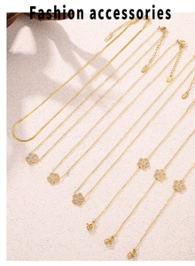 Macro view of gold flower jewelry set with zircon inlay and elegant snake bone chain